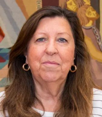 Retrato de uma mulher, Margarida Salema, vestida com uma camisola às riscas e brincos dourados.