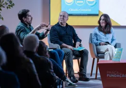 Uma plateia a assistir a um debate entre os humoristas Cláudio Almeida, Nuno Artur Silva e a economista Cláudia Custódio.