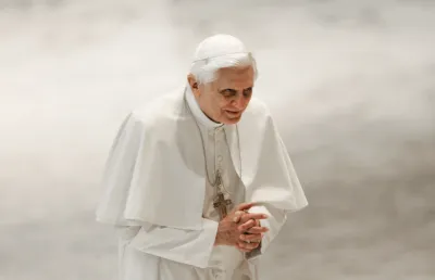 Um homem vestido de branco e envergando o solidéu sob um fundo neutro, o Papa Bento XVI, no Vaticano em 2006. Crédito: Shutterstock