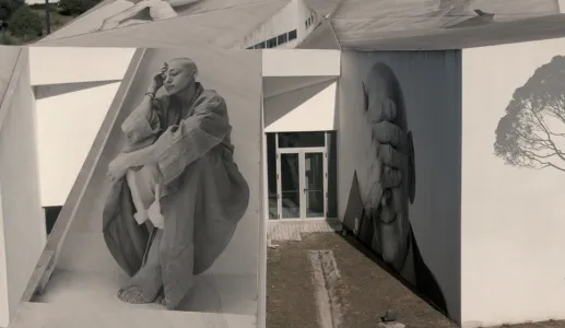 Imagens em preto e branco de pessoas em murais num edifício moderno.