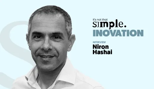A black-and-white close-up portrait of Niron Hashai, with a light blue background and the text “It’s not that simple. An interview on innovation.”