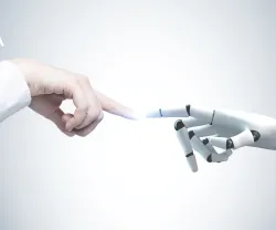 Imagem de uma mão humana que interage com uma mão robótica