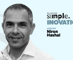 A black-and-white close-up portrait of Niron Hashai, with a light blue background and the text “It’s not that simple. An interview on innovation.”