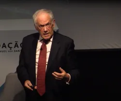 Peter Atkins a falar no palco do Auditório Mar da Palha do Oceanário de Lisboa, com o texto no fundo "Fundação Francisco Manuel dos Santos"