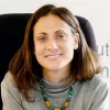 Retrato de Nathalie Tocci, diretora do Instituto Affari Internazionali, sentada numa cadeira.