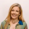 Retrato a cores da neurologista Raquel Gil-Gouveia, vestida com uma camisa às cores. Fundo claro.